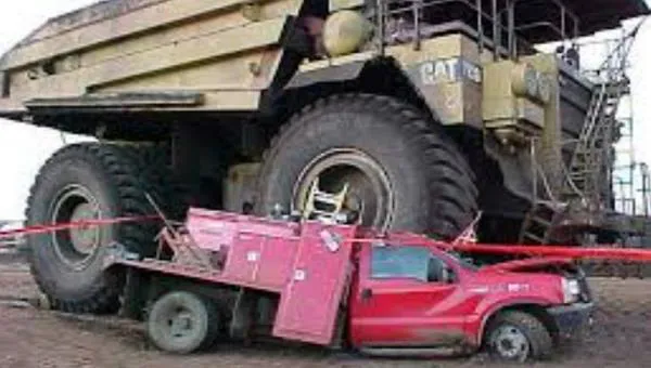 A light vehicle crushed under the wheel of a haul truck